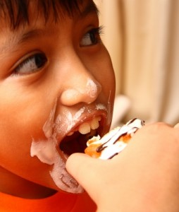 Photo of a child eating a cupcake