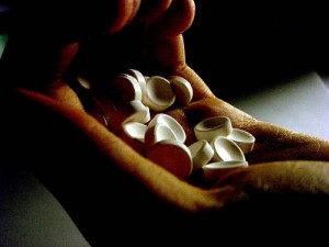 Photo of hand holding pills