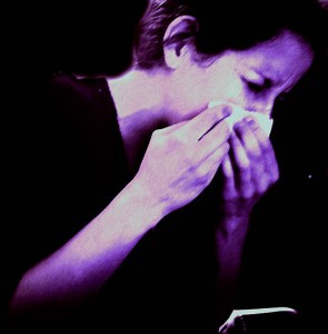 Photo of a woman sneezing