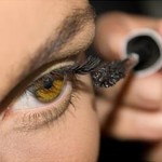 Photo of a woman applying eye make-up