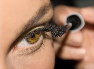 Photo of a woman applying eye make-up
