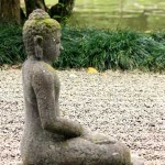 Photo of a statue of Buddha in a garden