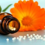 Photo of a homeopathic remedy and a flower