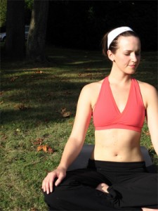 Photo of a woman meditating in a park