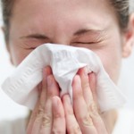 Photo of a woman sneezing