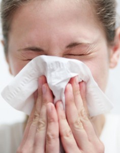 Photo of a woman sneezing