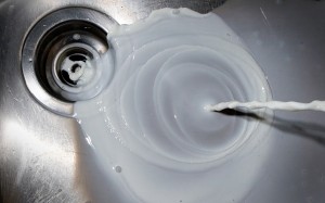 Photo of milk being poured down the drain