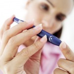 Photo of a woman testing her blood sugar levels