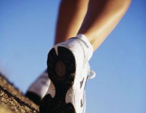 Photo of feet walking against blue sky backdrop