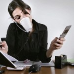 Photo of a woman multitasking at her desk