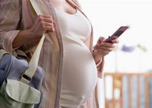 Photo of a pregnant woman with a cell phone