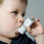 Photo of a child with an asthma inhaler