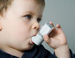 Photo of a child with an asthma inhaler