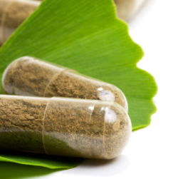 Photo of herbal capsules on a green leaf