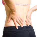 Photo of a woman with her hands on her lower back