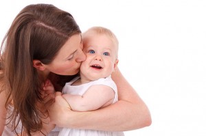 Photo of a mother kissing her baby