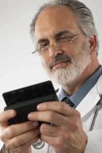 Photo of a doctor using a mobile phone to tweet