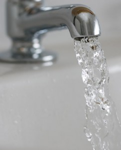 Close up photo of water comoing out of a tap