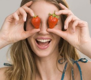 Photo of a happy woman with strawberries