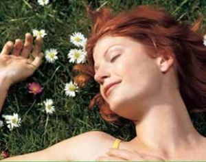 Photo of a woman sleeping in a field of flowers