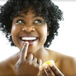 Photo of a woman using lip balm