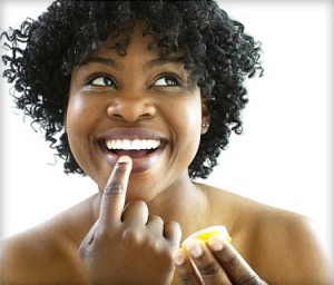 Photo of a woman using lip balm