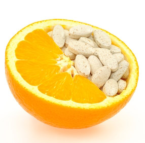 Photo of an orange and vitamin C supplements