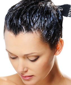 Photo of a woman using hair dye