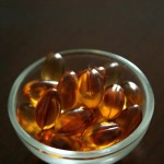 Photo of a small bowl of vitamin E capsules