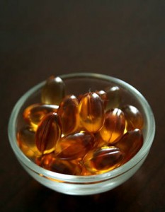Photo of a small bowl of vitamin E capsules