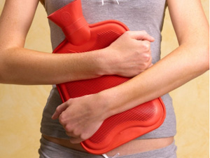Photo of a woman holding a hot water bottle over her stomach