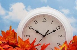 Photo of a clock sitting in autumn leaves