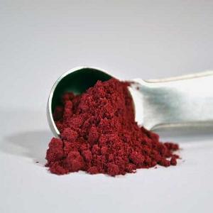 Photo of a scoop of red yeast rice