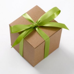 Photo of a gift wrapped in brown paper with a green ribbon