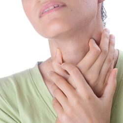 Photo of a woman holding a sore throat