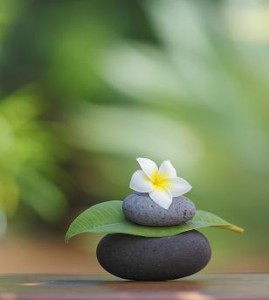 Photo of stacked stones against a peaceful green background