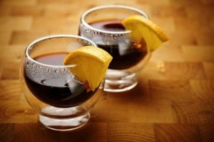 Photo of mulled wine served with lemon wedges