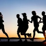 Photo of adults running at sunset