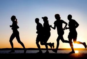 Photo of adults running at sunset