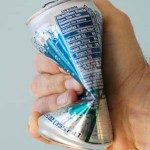 Photo of a hand crushing a diet soda can