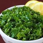Photo of a bowl of kale with a lemon slice