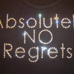 Photo of a t-shirt with "Absolutely No Regrets" spelled out on it in lights