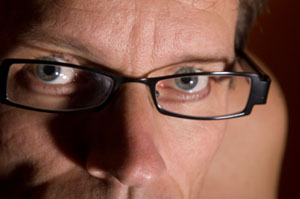 Close up photo of a man wearing glasses
