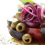 Photo of a salad of fresh Mediterranean vegetables in olive oil