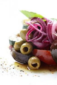 Photo of a salad of fresh Mediterranean vegetables in olive oil