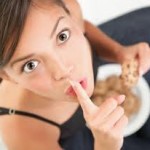 Photo of a woman secretly eating cake