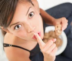 Photo of a woman secretly eating cake