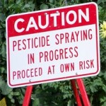 Photo of a sign warning of pesticide spraying
