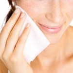 Photo of a woman using a facial wipe
