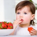 Photo of a child eating strawberries